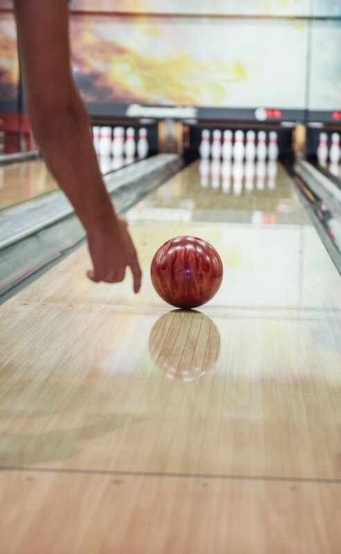 Bowling ball rolling down a lane at a nearby bowling alley