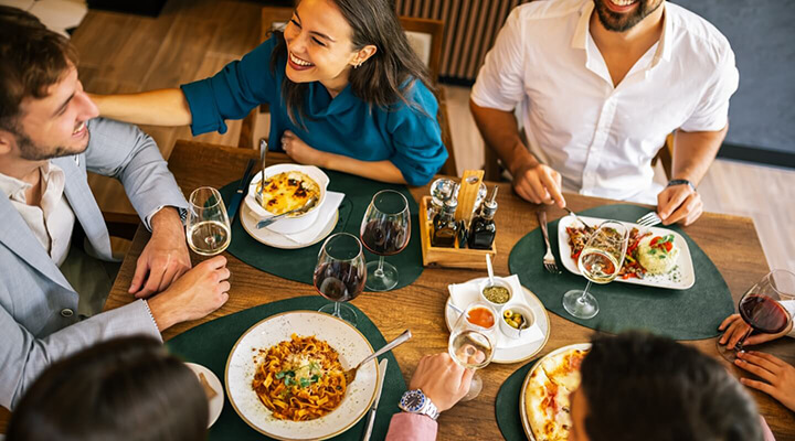 Group of friends dining together at a nearby restaurant