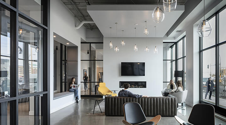Everlake lobby lounge with modern seating, fireplace, and tall windows