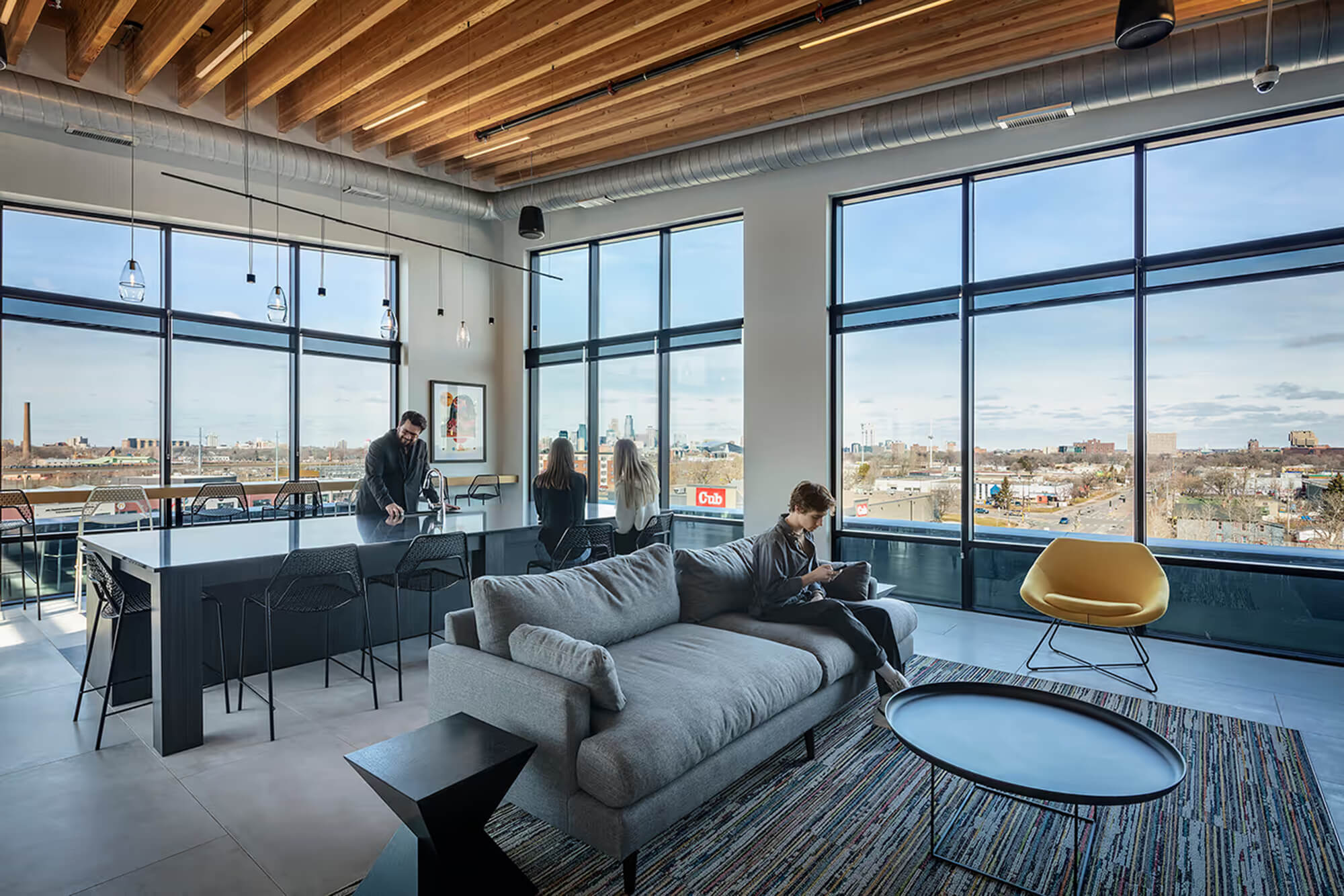 Sky lounge with seating, kitchen island, and expansive city views