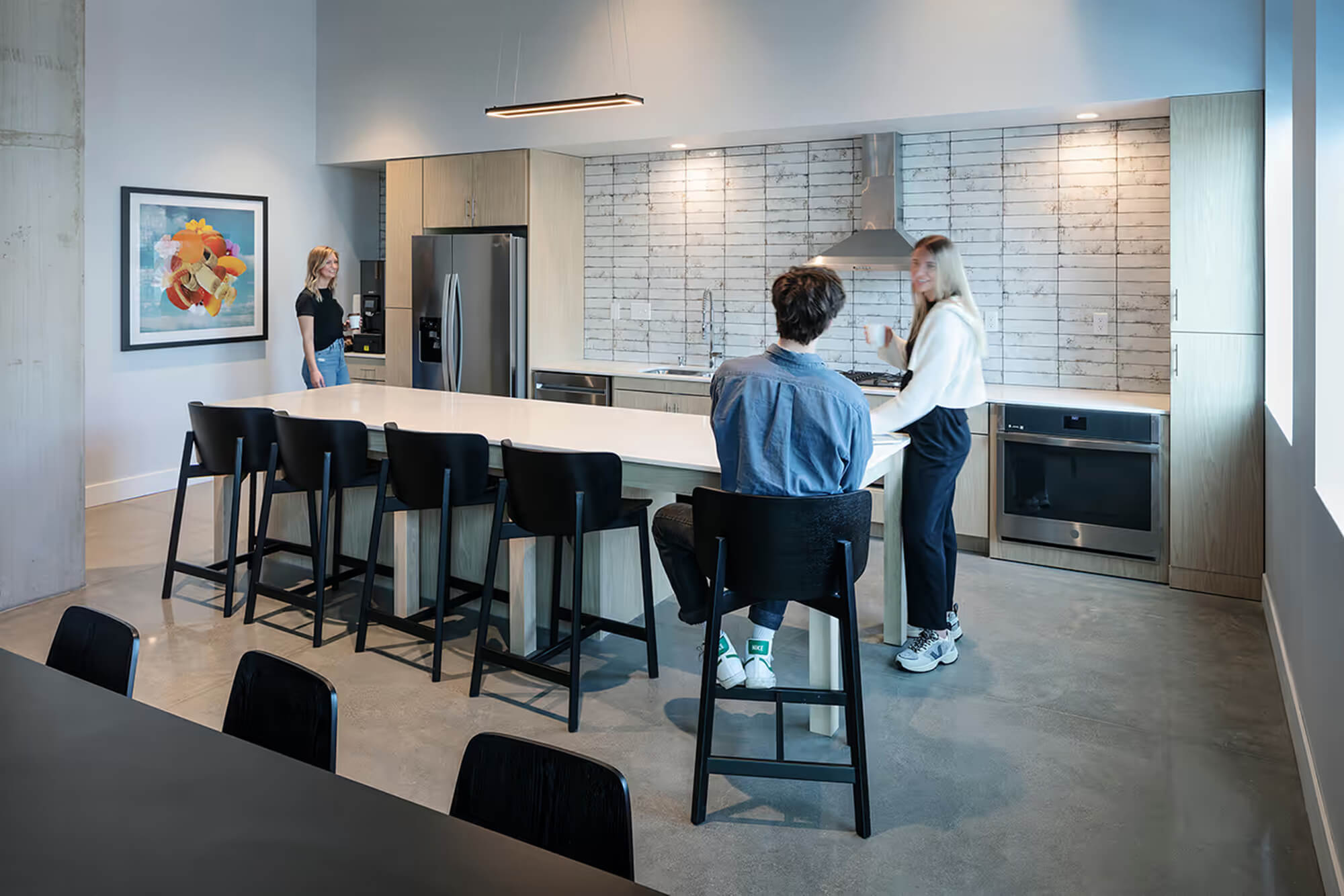 Community kitchen with island seating and residents gathered together