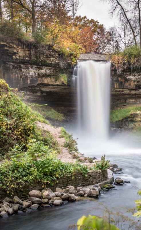 Waterfall surrounded by trees and rocks in a nearby park