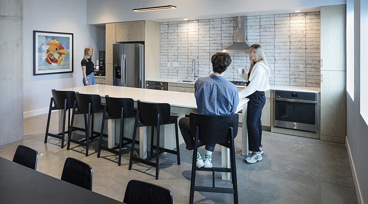 Everlake community kitchen with island seating and residents gathering